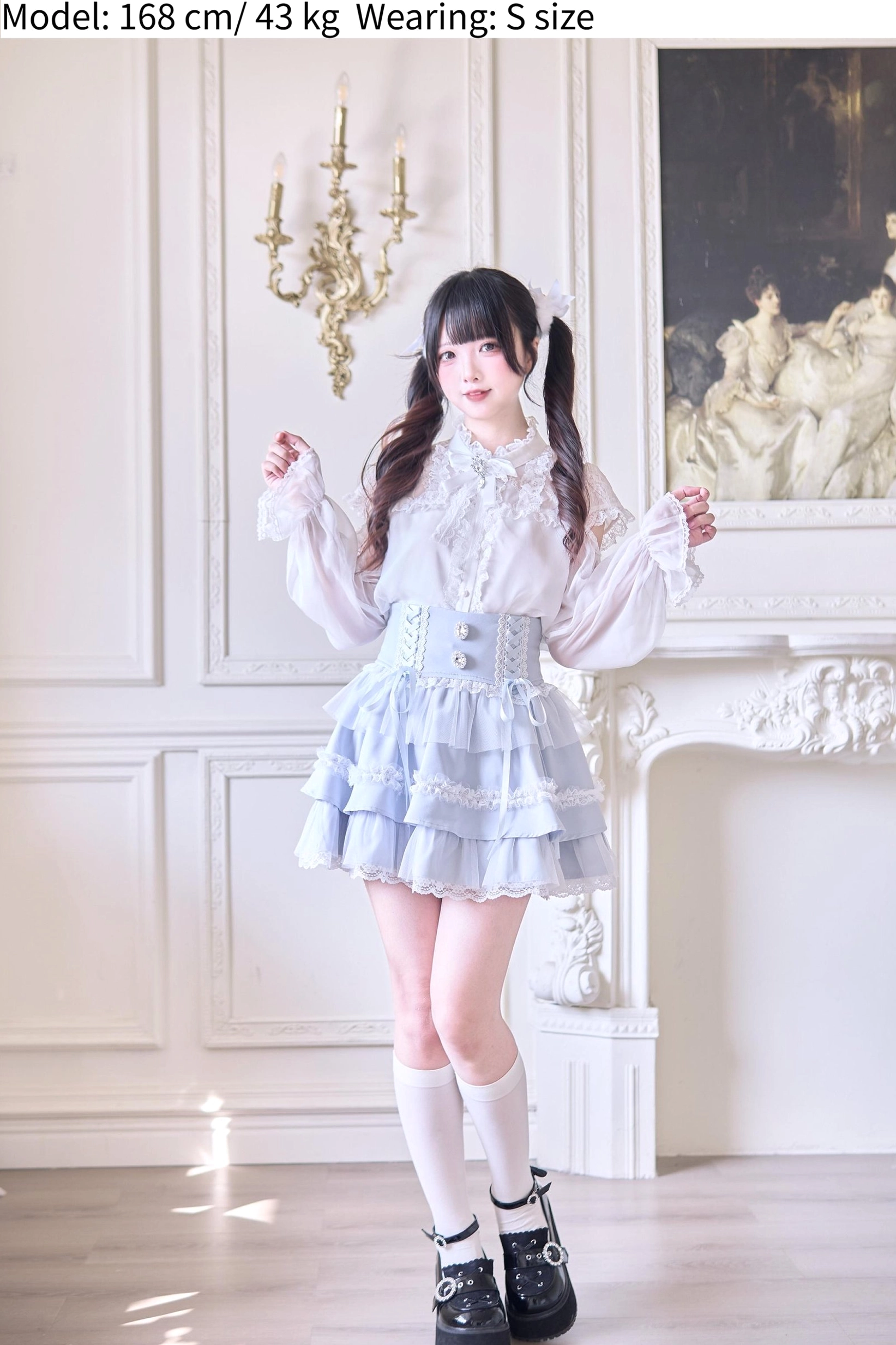 Full-body back view of tiered ruffle Jirai Kei skirt in light blue showcasing layered construction and mesh hem panel