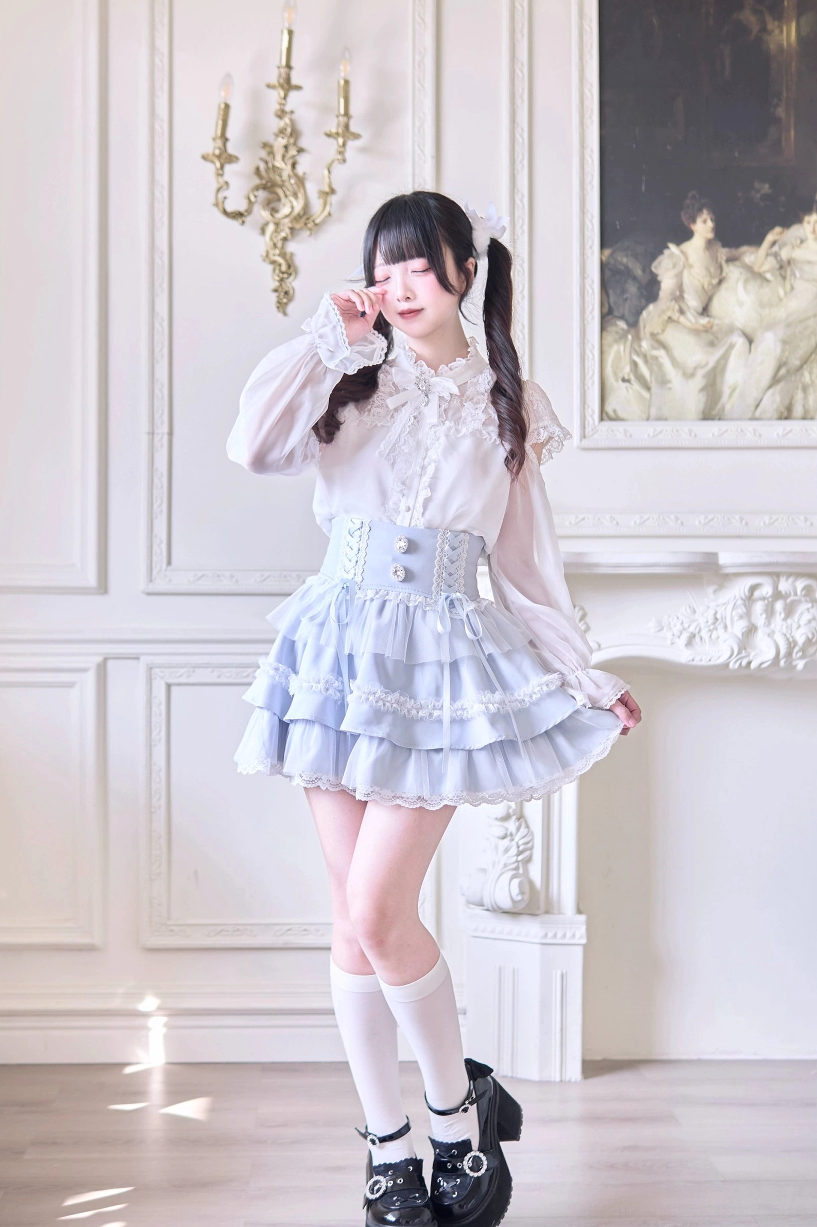 Full-body side angle of Jirai Kei ruffle skirt in water blue paired with platform loafers and aesthetic styling elements