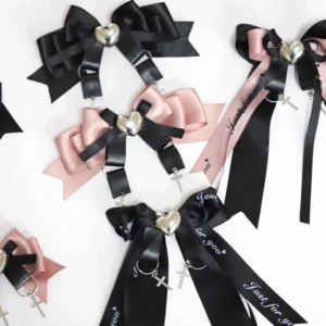 Jirai Kei ryousangata bow hair clips collection overhead flat lay featuring black and pink satin bows with silver heart and cross pendant decorations multiple color options