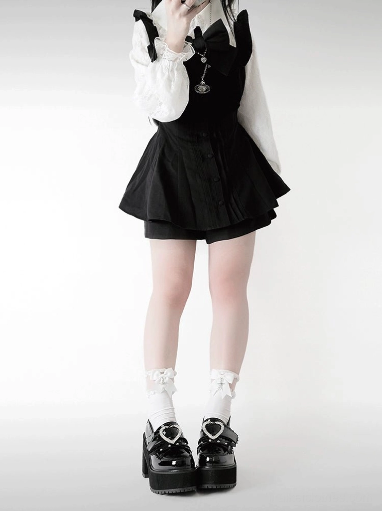 Jirai Kei platform loafers with glossy patent leather, heart-shaped rhinestone buckle, thick chunky block heel, and frilled bow white ankle socks worn by model in black and white maid-style jirai kei uniform full front view