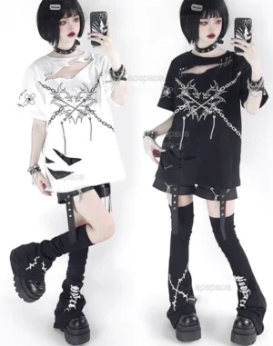 Two models wearing matching black and white jirai kei distressed safety pin t-shirts with chest cutouts and chain print graphics in mirror selfie pose