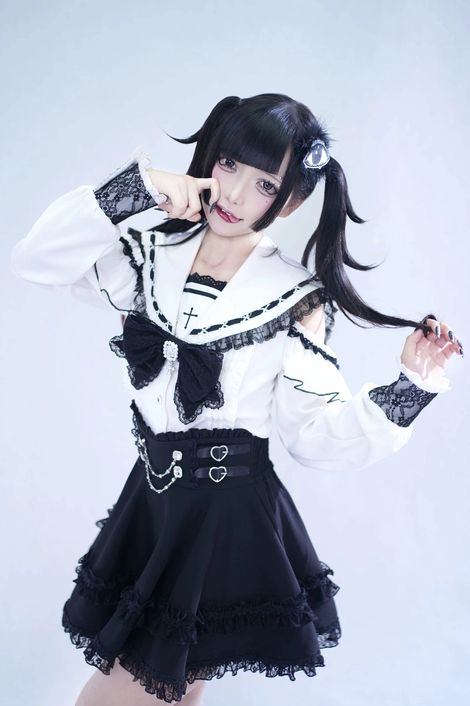 Half-body front view of Jirai Kei sailor collar blouse showing lace cuffs, large chest rhinestone bow, and striped inner collar detail