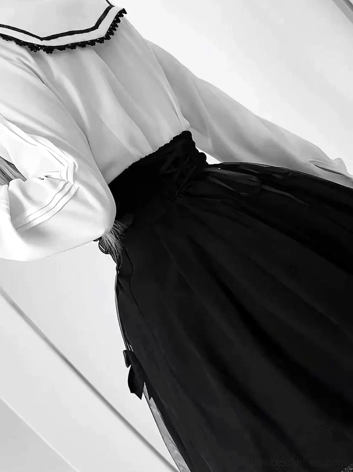 Alternative styling detail showing Jirai Kei sailor collar blouse with black high-waist skirt focusing on waist bow detail, tulle sheer overlay hem layer, and fitted high-rise proportions
