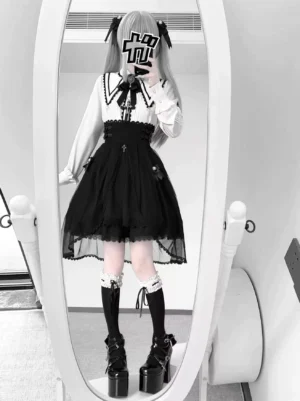 Alternative color styling Jirai Kei outfit showing white sailor-inspired collar blouse paired with black tulle high-waist skirt featuring lace-up back details and decorative buckles, full-body mirror view with platform boots and lace stockings