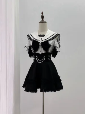 Jirai Kei sailor collar lace blouse with cross pendant detachable bow tie and pearl chain skirt front view on mannequin black white aesthetic