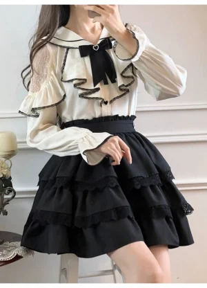 Jirai Kei sailor collar blouse with tiered ruffled skirt two-piece set - long-sleeve white blouse with black ruffled skirt on model, full-body three-quarter view