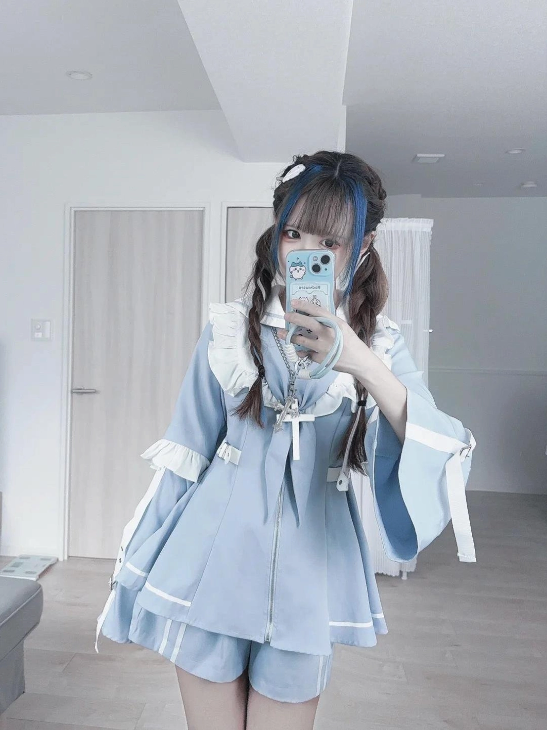 Styling inspiration image of pastel blue Jirai Kei sailor dress and shorts ensemble paired with white thigh highs, accessories, and coordinating fashion pieces