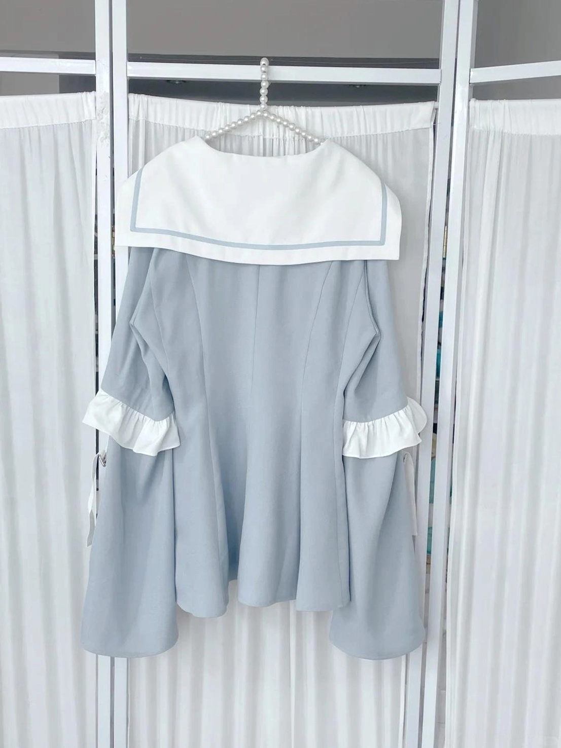 Three-quarter angle view of pastel blue Jirai Kei sailor dress and shorts set displaying overall silhouette, sleeve configuration, and hemline details
