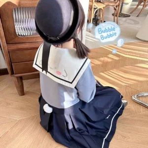 Jirai Kei puppy theme sailor uniform rear view showcasing fluffy pom-pom tail decoration collar puppy face embroidery black top hat wooden indoor setting