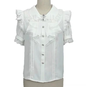 Pure white Jirai Kei short sleeve blouse with grey lace trim, large white bow brooch, and gem front closure buttons on dress form, minimalist color palette