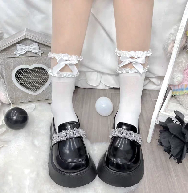 Dual aesthetic comparison showing black and white short ankle Jirai Kei socks with ruffled cuffs and cross details paired with matching platform loafers