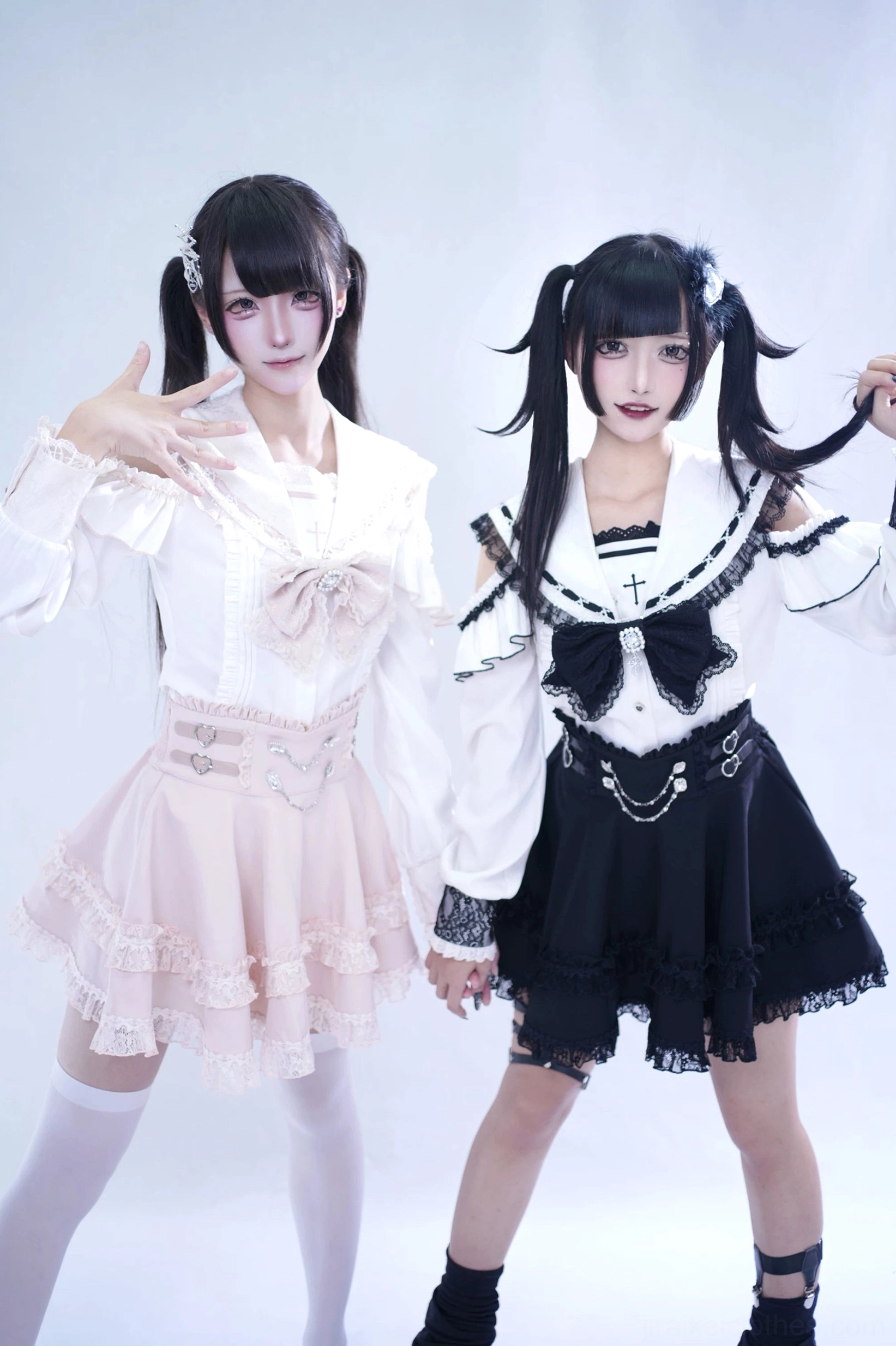 Sailor collar Jirai Kei skirt close-up showing heart-shaped waist buckles, front rhinestone chain accent, and mini length proportion