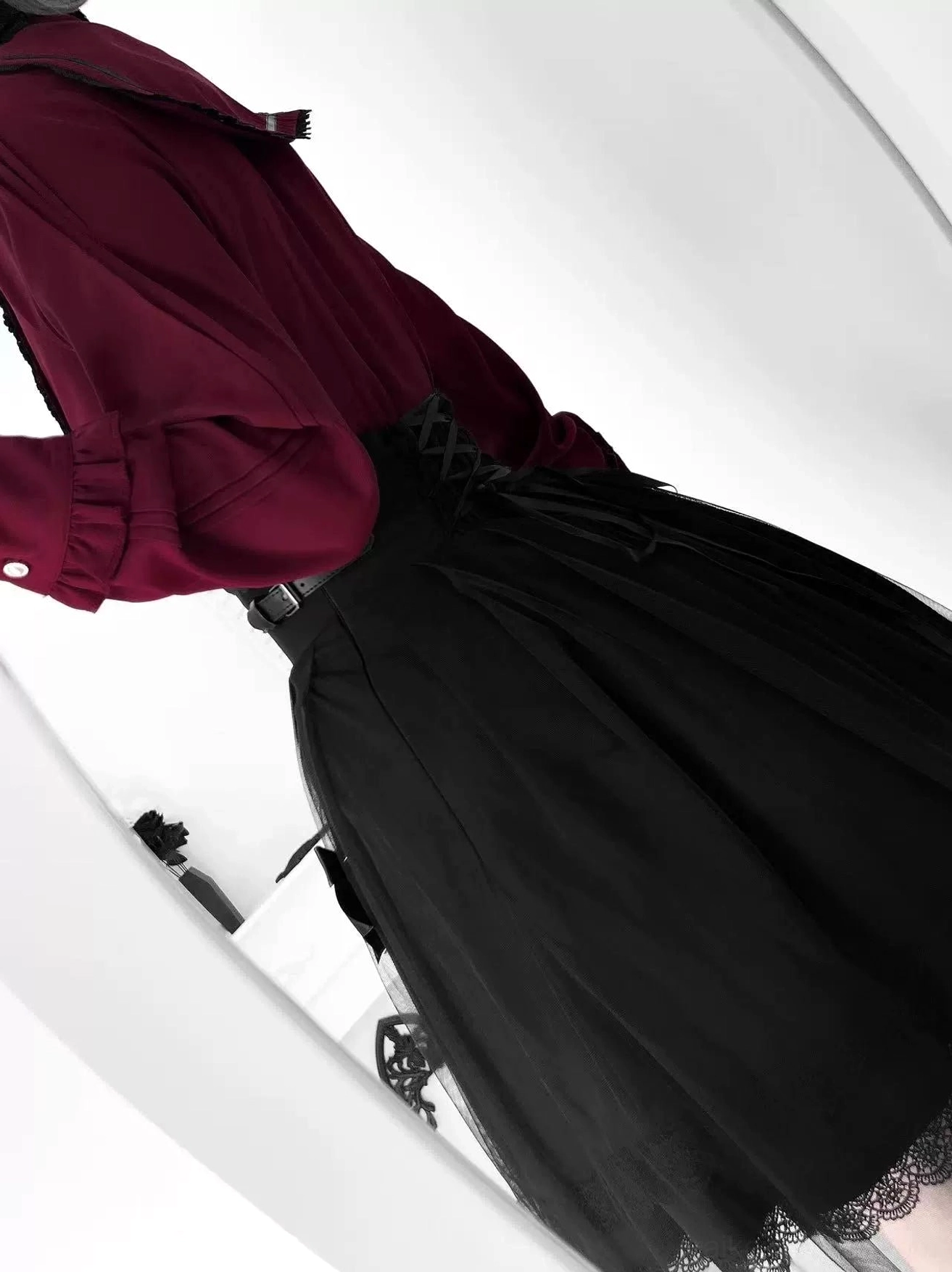Side waist detail of Jirai Kei skirt showing functional lace-up corset back, metal buckle straps, and structural waist construction that defines the high-rise silhouette