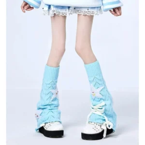 Sky blue Jirai Kei knit leg warmers with lace-up front detail and star embellishments, worn with casual Y2K outfit on studio plain background, showing hollow knit texture and decorative star patches