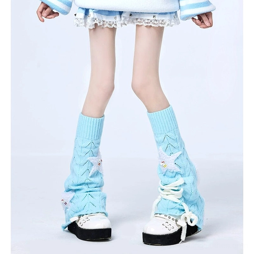 Sky blue Jirai Kei knit leg warmers with lace-up front detail and star embellishments, worn with casual Y2K outfit on studio plain background, showing hollow knit texture and decorative star patches