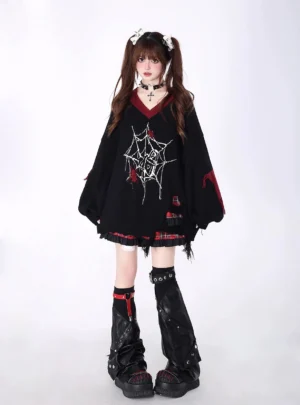 Black Jirai Kei oversized sweater featuring spiderweb print pattern and distressed frayed hem, modeled in white studio with full-body front perspective
