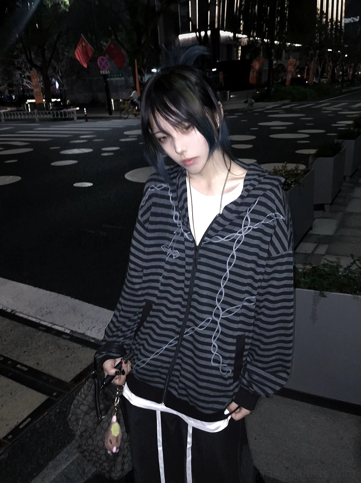 Jirai Kei gothic striped hoodie worn layered over mesh top and structured undergarments showing versatile styling possibilities