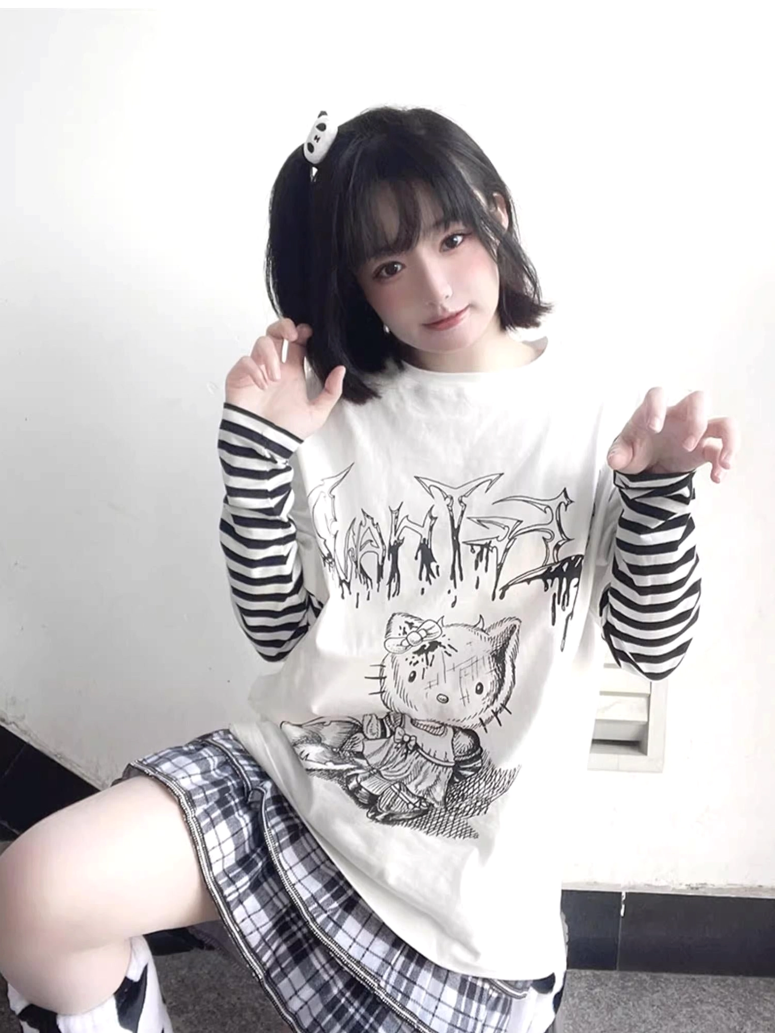 Back view of jirai kei fake two-piece striped long sleeve punk tee showing overall silhouette and design composition