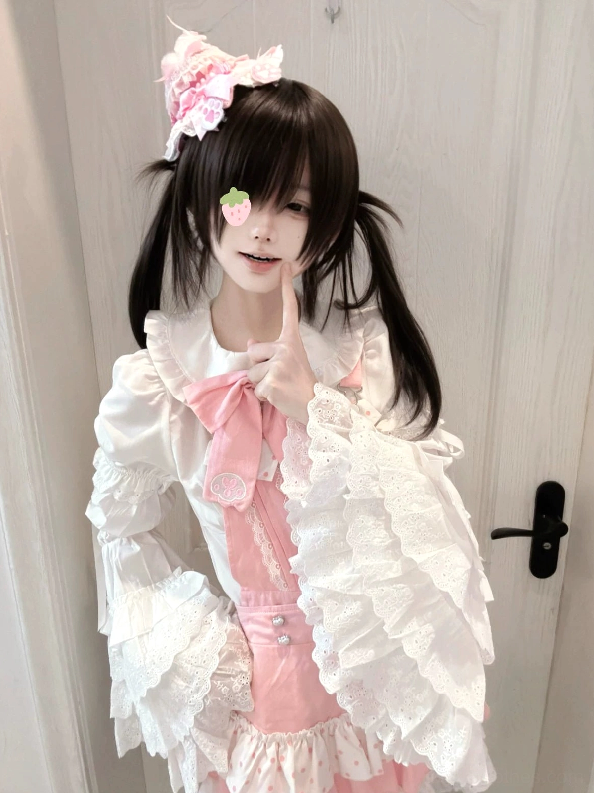 Close-up front view of jirai kei suspender dress, flared ruffled lace sleeves, detailed pink bow necktie, polka dot and lace hem details, pink and white color scheme
