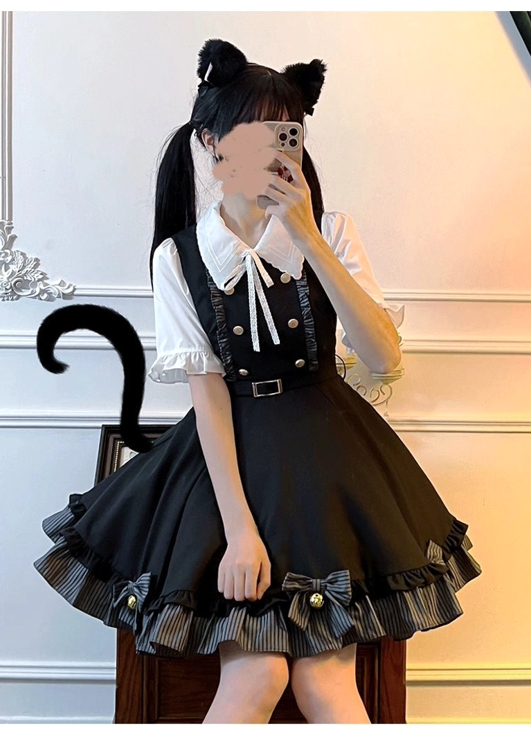 Three-quarter view mirror selfie of Jirai Kei outfit featuring cat ear themed styling with black suspender skirt decorated with striped ruffled trim and matching waist belt on wooden chair background