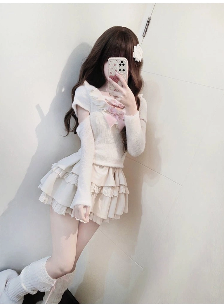 Jirai Kei white sweater skirt combination styled with lifted leg pose showcasing tiered ruffle construction and elastic waistband comfort, off-shoulder design and soft fuzzy texture