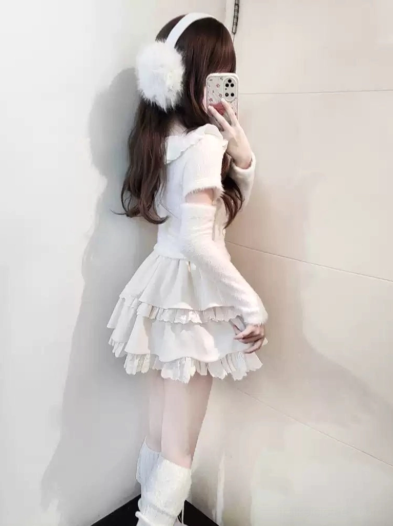 Back view of Jirai Kei white sweater skirt set showing tiered ruffle construction without chest bow decoration, fuzzy knit fabric texture and rear silhouette with white leg warmers