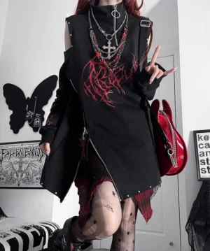 Black and red Jirai Kei oversized sweatshirt with bold gothic print, side full-body view on punk model with red guitar bag in gothic room, stud trims visible on shoulders and hem