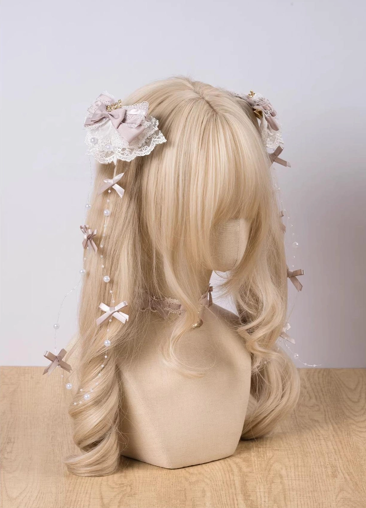 Twin Jirai Kei hair clips set with dusty pink beige bows, lace trim, and cross-shaped pearl chain bows on blonde wig