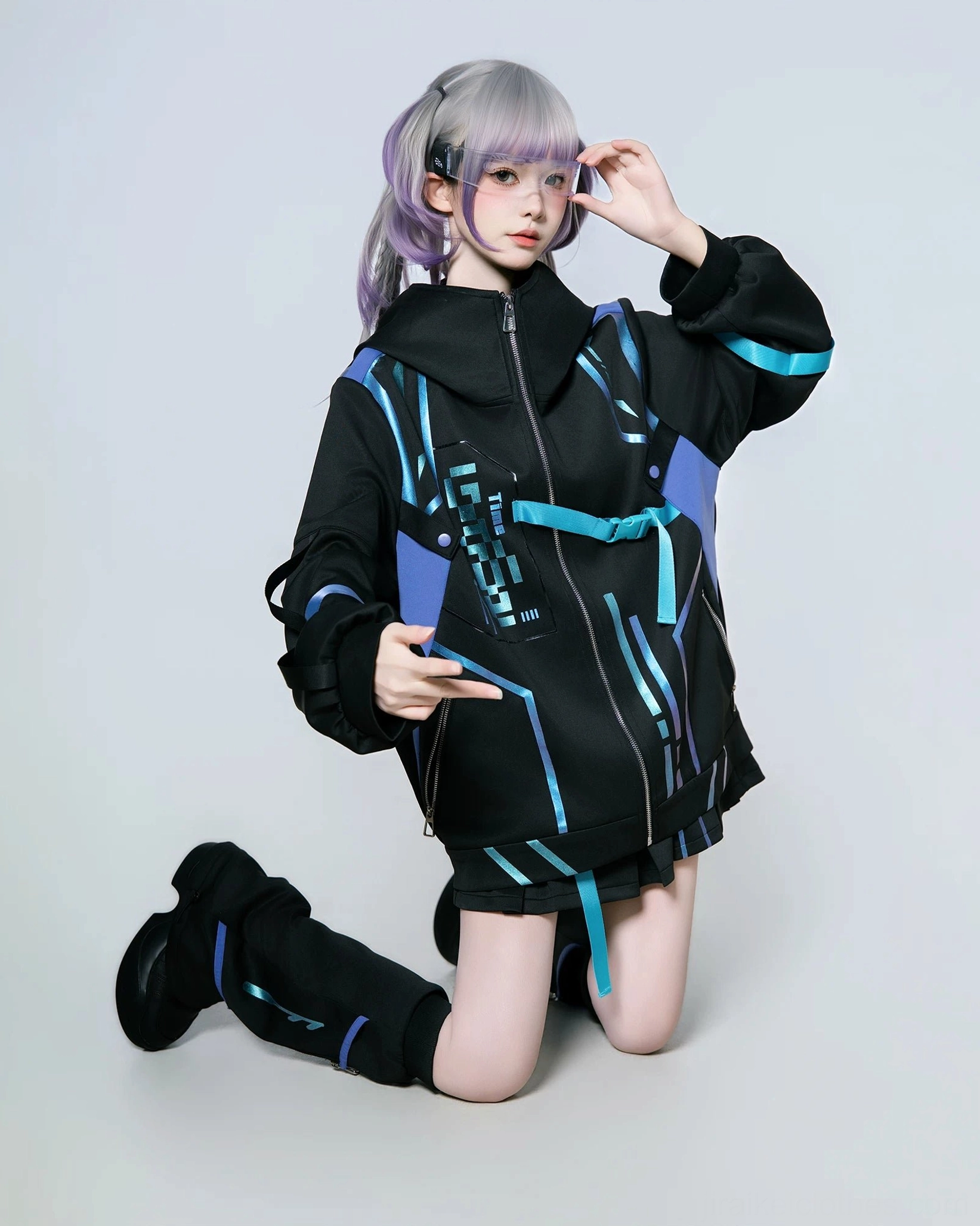 Jirai Kei techwear jacket and skort ensemble displayed on model showing oversized hood prominence, functional side pockets, and pleated skort feminine details