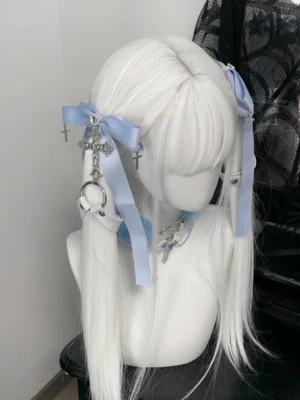 Jirai Kei twin ponytail hair clips with light blue tulle bow, silver cross charms, and heart rhinestone on white mannequin with lace background - left three-quarter view