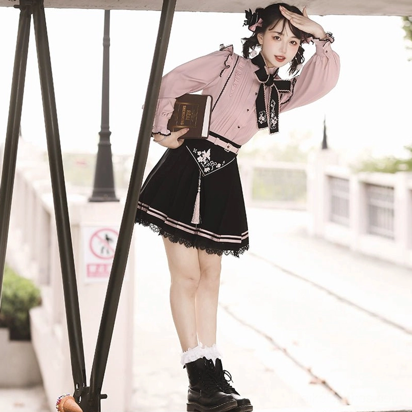 Full body side shot of Jirai Kei fashion set on model wearing black combat boots and white frilled socks, hand-on-hip pose, urban street background