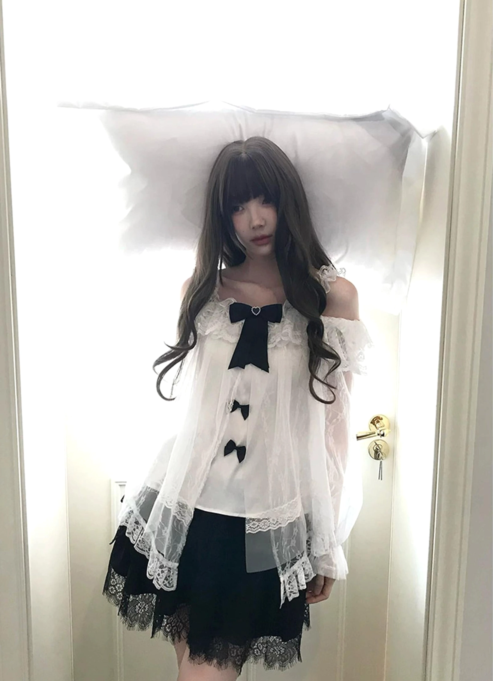 Flat lay styling composition showing complete black-and-white Jirai Kei two-piece ensemble with blouse and tulle skirt displayed with complementary accessories and styling elements