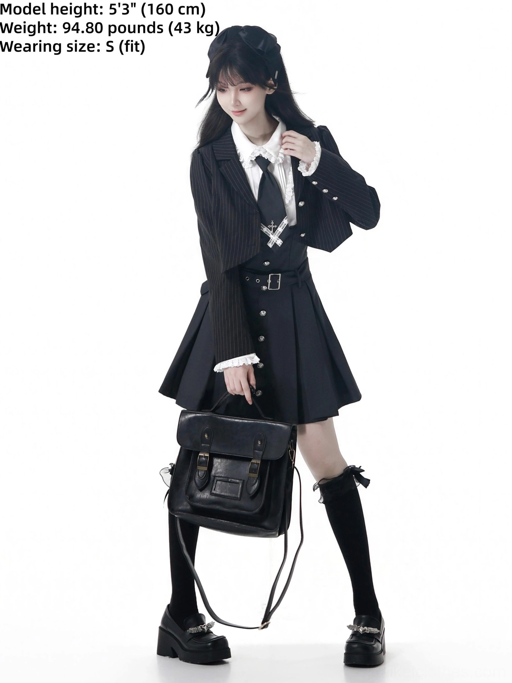 Jirai Kei school uniform styling details showing metal campus badge on blazer chest, belted waist, pleated skirt suspender straps, and bow knee-high socks on female model