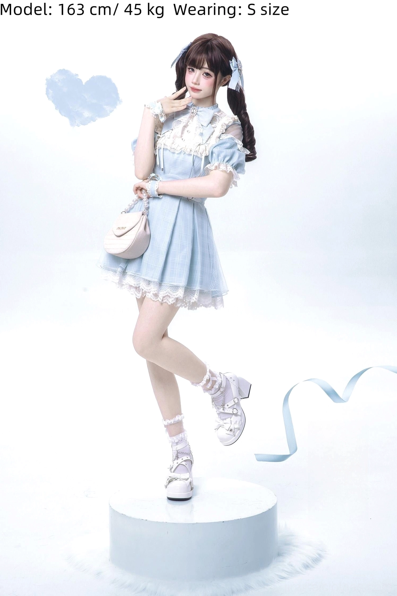 Water blue Jirai Kei dress side three-quarter full shot with blue twin ponytail hair bows pink heart handbag and white studio background