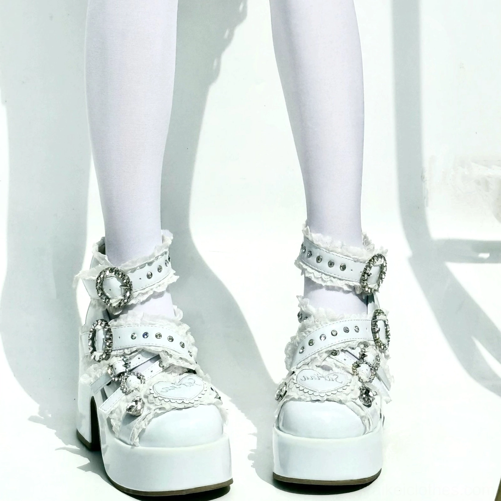 Water blue Jirai Kei platform high heels with multiple crystal buckles and heart accents on model legs