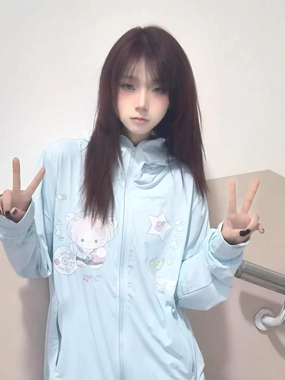 Water blue jirai kei UV protection jacket with functional design elements including pockets, detachable hood, and whimsical cartoon print embellishments