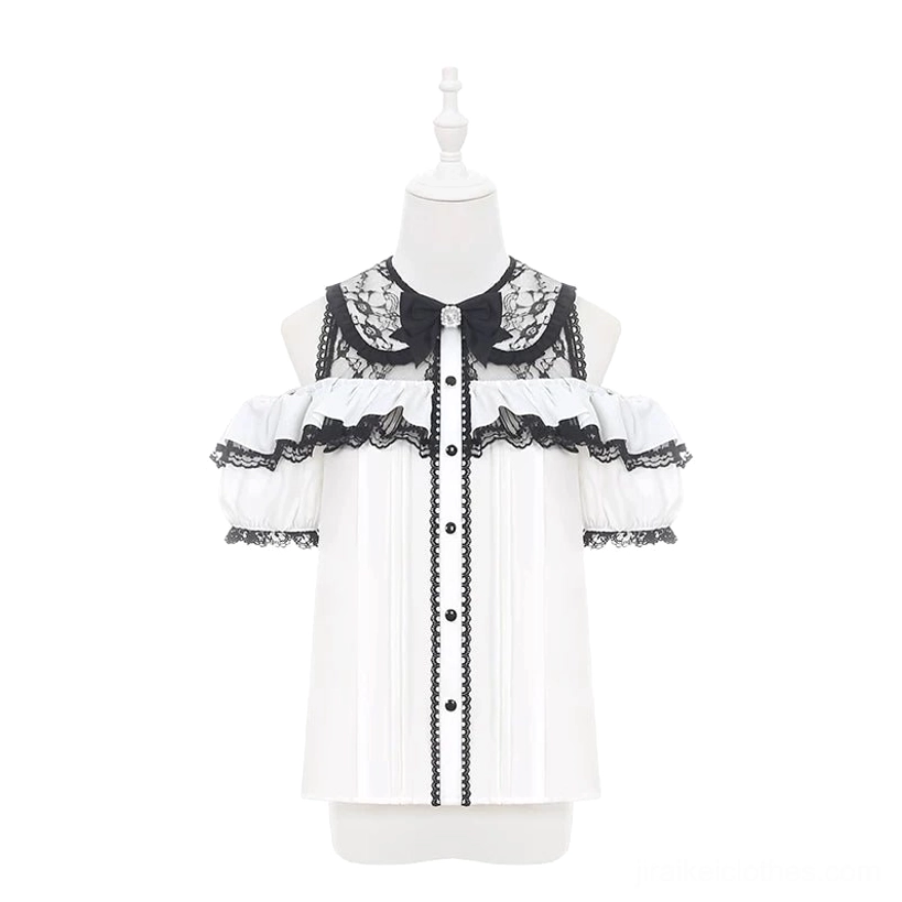 White off-shoulder Jirai Kei blouse with black lace trims displayed on mannequin showing off-shoulder ruffled sleeves, front button design, and rhinestone bow neckline detail
