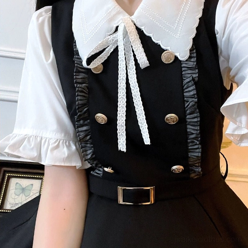 Flat close-up detail shot of Jirai Kei blouse upper section featuring white lace collar bow, ruffled short sleeves, and shiny gold metal buttons on preppy school uniform