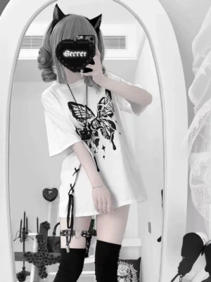 White gothic butterfly skull print oversized Jirai Kei t-shirt with detachable zipper shoulder worn by model with cat ear hair clips and thigh-high socks