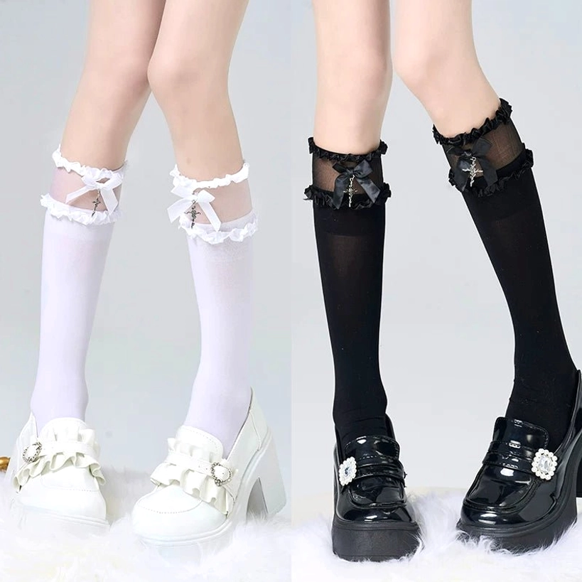 White calf-length lolita socks with cross pendant worn in bedroom aesthetic scene with black lolita dress and plush rabbit styling