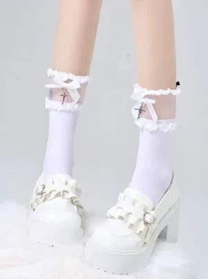 White calf-length lolita socks with lace ruffled bow and cross ornament displayed on legs with white platform loafers and fluffy cushion styling