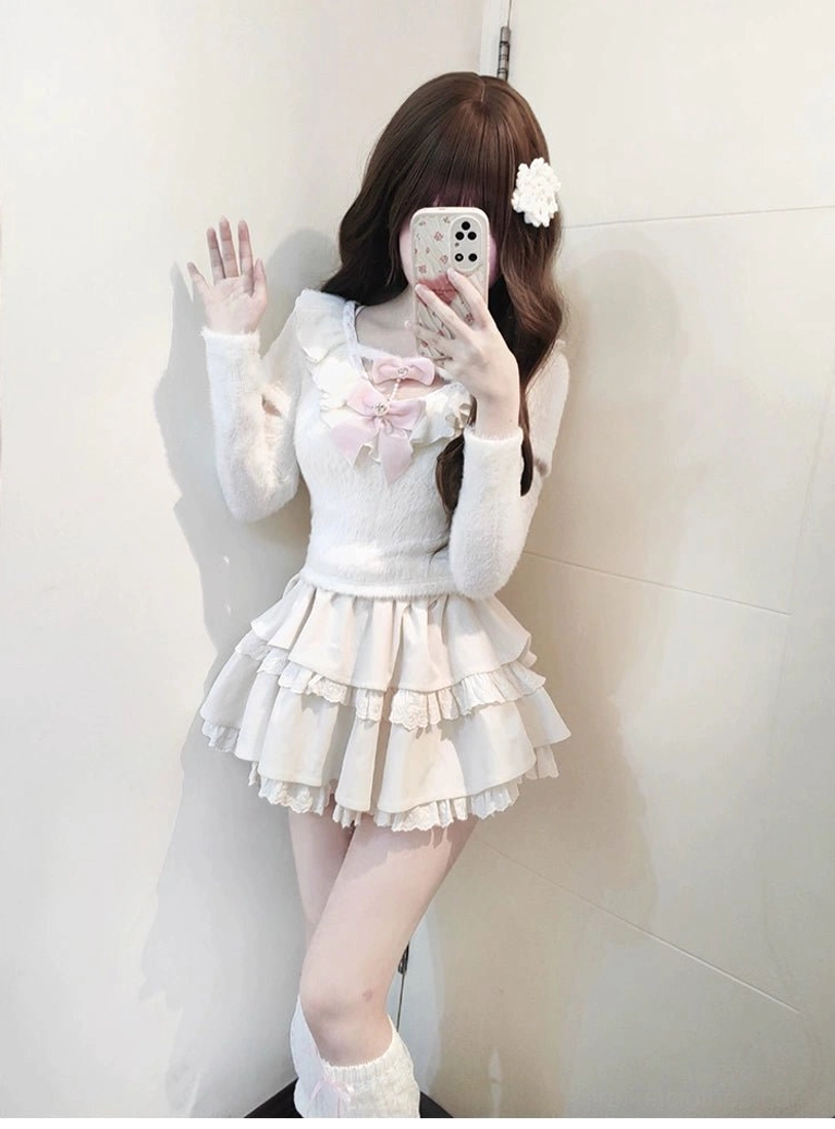 Sweet Jirai Kei white sweater skirt outfit displaying full set with detachable pearl chain bow, waving pose showing sleeve construction and tiered ruffles, perfect styling inspiration for subculture fashion