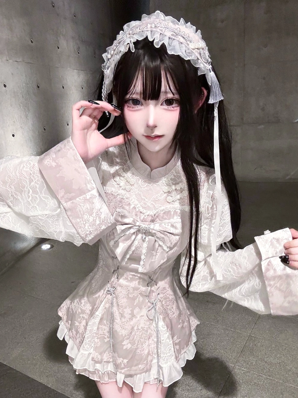 White lace Jirai Kei headband worn by model in pink Chinese Lolita dress, eye-level portrait styling, coordinated hair accessory with outfit, Oriental fashion look
