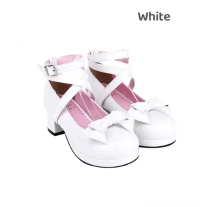 Pristine white Jirai Kei round toe mid-heel Mary Jane shoes with criss-cross buckle ankle straps and detachable pink bow, paired display on white background