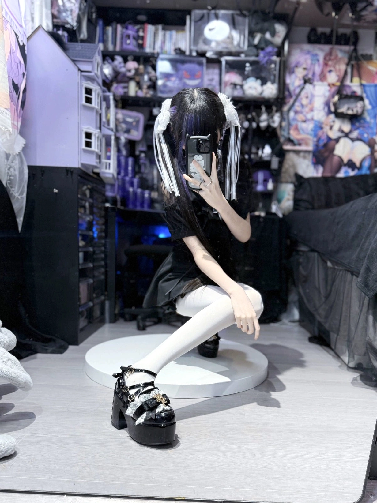 Three-quarter front view white patent leather Jirai Kei platform heels on display showing full shoe silhouette front lace bow and complete buckle strap configuration