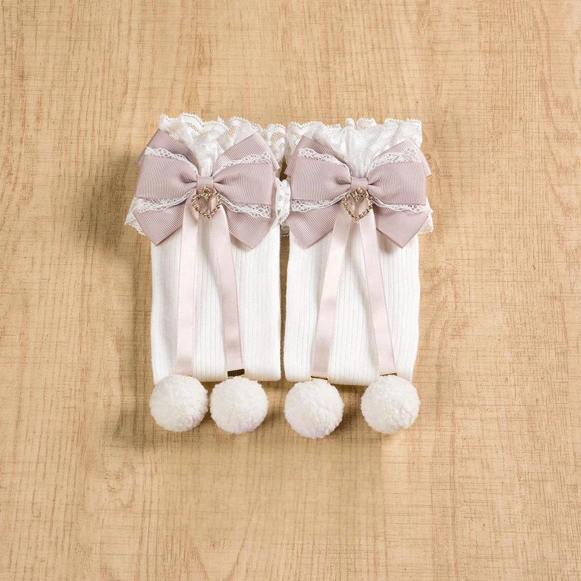 Jirai Kei white-pink mid-calf socks front view showing delicate white-pink combination with lace cuff pink bow and white pom-pom on model