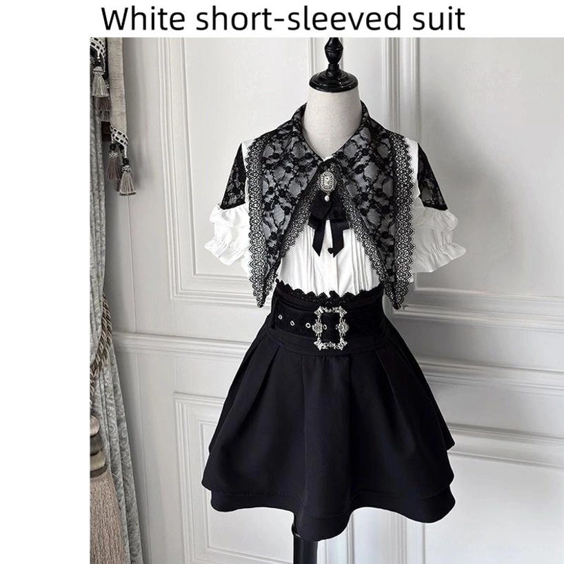 White short-sleeved Jirai Kei blouse with black lace capelet and black A-line skirt mannequin display with decorative belt