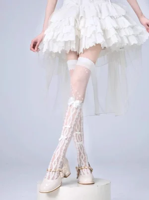 White striped Jirai Kei over-the-knee velvet socks with delicate butterfly bow patterns and lace trim, styled on model wearing white ruffled dress and beige Mary Jane shoes, front low-angle view showcasing sheer mesh and hollow vine details