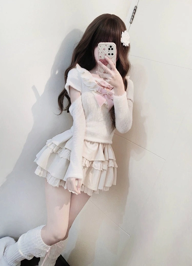 Front facing mirror selfie of Jirai Kei sweater and tiered skirt set showing complete ensemble with off-shoulder style, relaxed stance displaying comfortable fuzzy knit sweater and layered ruffle skirt