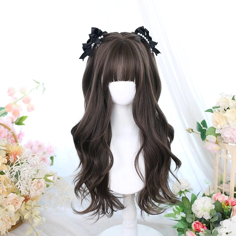 Long curly dark brown Jirai Kei wig with straight black bangs and decorative hair bows displayed on mannequin with floral background